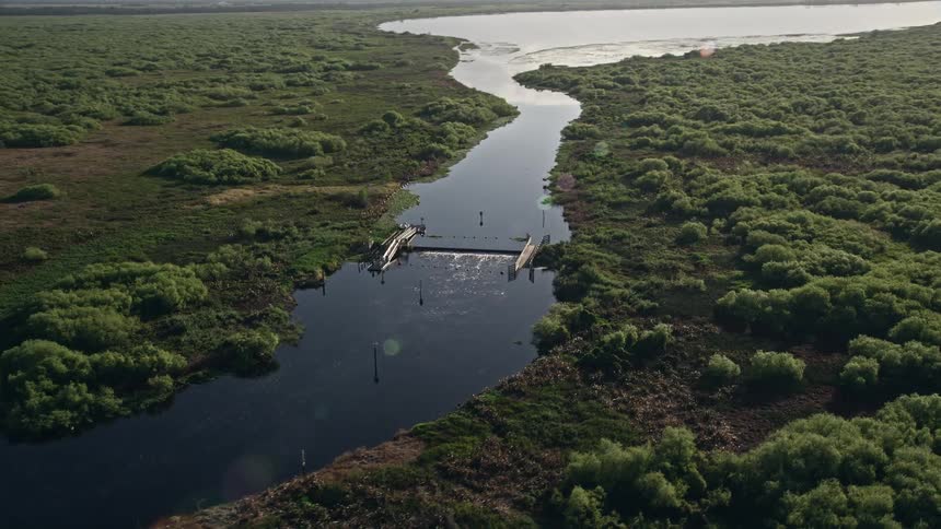 A stunning sunrise view of a levee on St Johns River in Orlando Florida captured in aerial footage