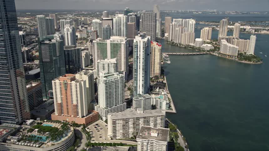 Aerial footage of Jade at Brickell Bay a superstructure high rise building standing tall in Downtown Miami Florida surrounded by other skyscrapers along the coast