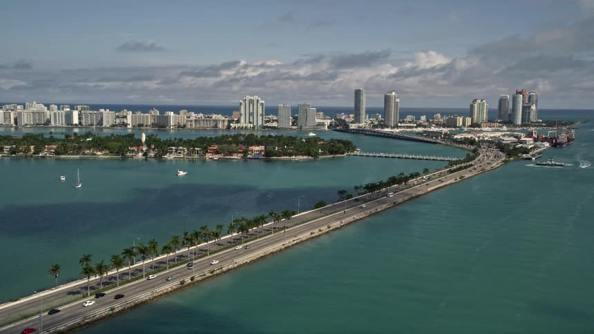 Light traffic seen on the MacArthur Causeway as cars travel towards and from South Beach Florida in 5K aerial footage