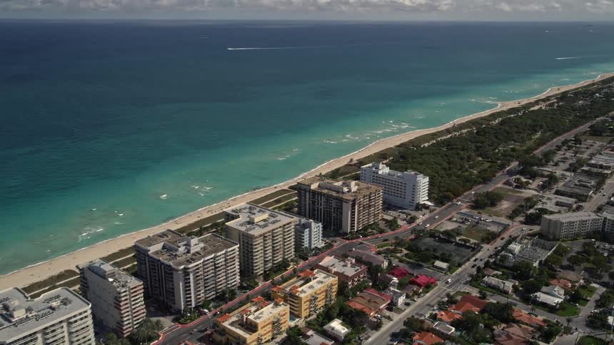 Aerial view of oceanfront apartments beach and park in Surfside South Florida
