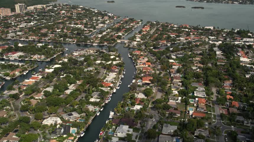 Aerial footage of canals running through residential areas in Keystone Islands Florida with a sunny and peaceful ambiance