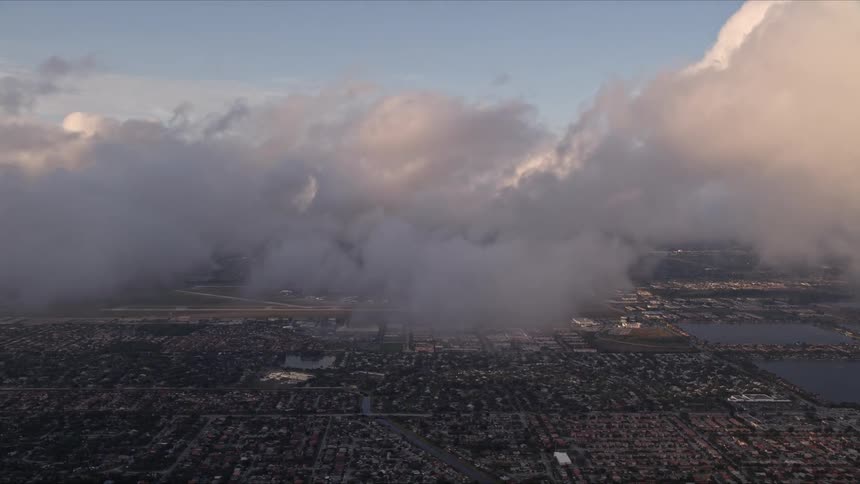 Aerial footage at dusk captures cloudy skies over suburban Kendall suburbs during sunset in Florida