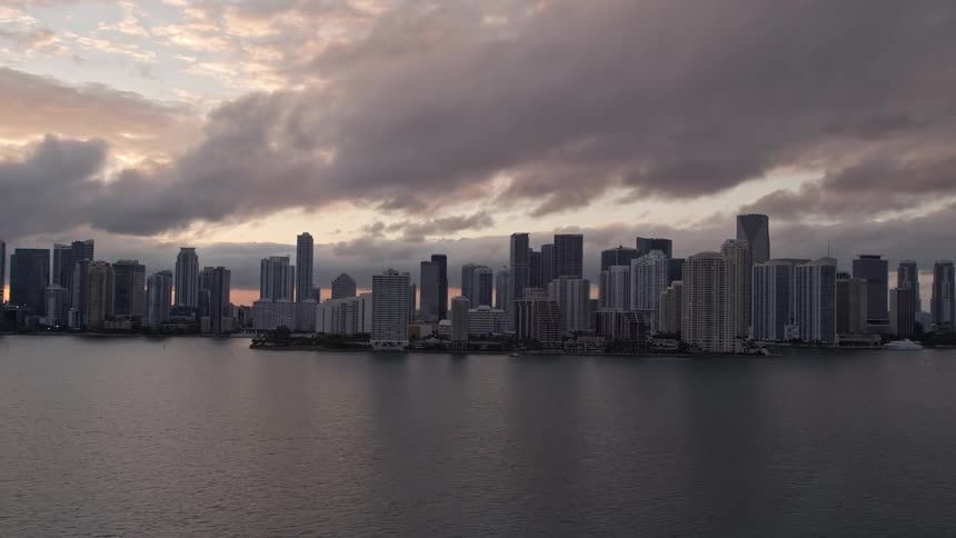 Aerial view at sunset of the Downtown Miami skyline and high rises along the shoreline as seen from Biscayne Bay in Florida