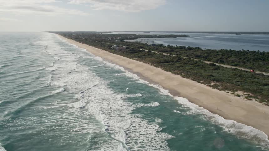 Approaching beachfront homes in Melbourne Beach Florida with mesmerizing aerial views from a wide angle perspective