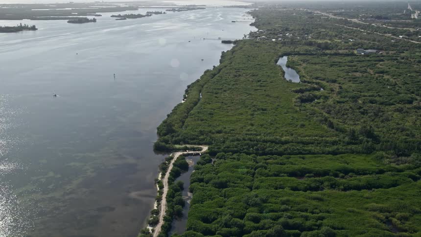 An aerial view of the Indian River shoreline with surrounding marshes near Fort Pierce Florida on a sunny day