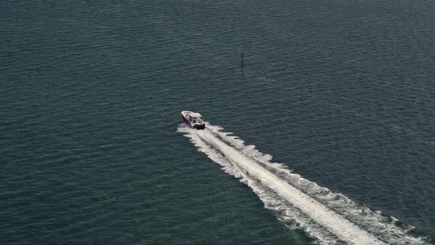 A speedboat enjoys a rapid ride across the scenic Biscayne Bay in Florida under the warm sunshine