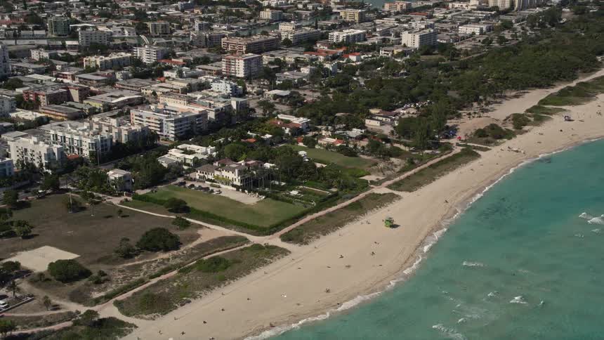 Approaching Miami Beach oceanfront homes with stunning views of the shoreline and leisure activities