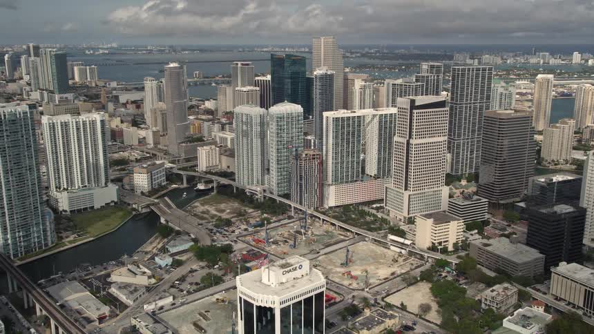 Aerial footage showcasing Downtown Miamis impressive skyline with towering high-rises set against the scenic backdrop of the Gulf Coast and Miami River