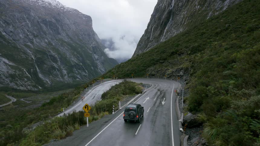 Vehicle making a hairpin turn  in a mountainous area