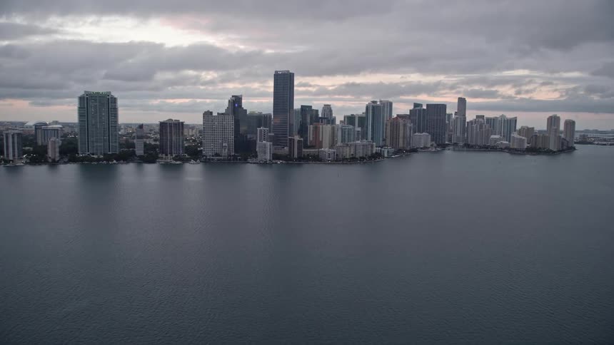 The clip features a 5K aerial view of the Rickenbacker Causeway tilting up to reveal downtown Miami at sunset with a breathtaking view of the coastline skyline and light traffic