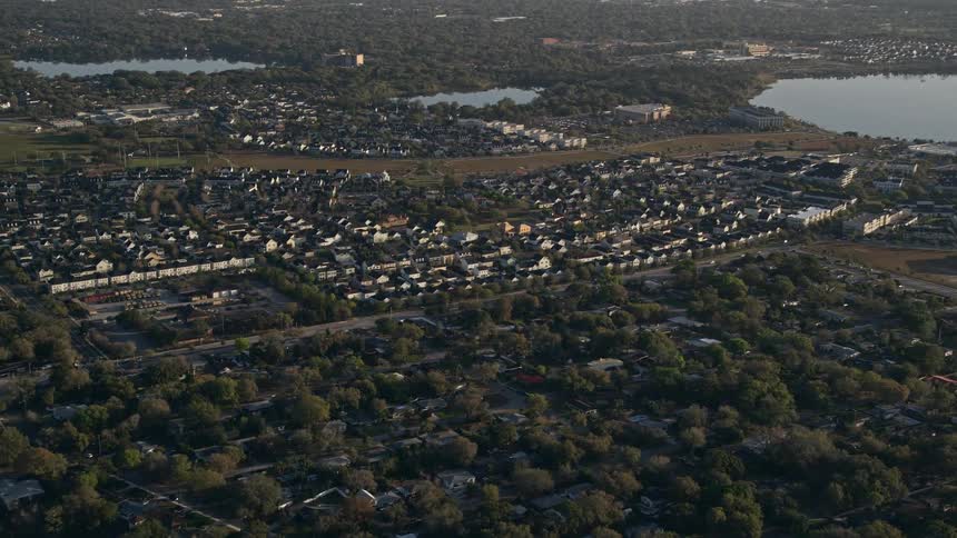 Aerial view of a suburban Orlando neighborhood beside Lake Baldwin during sunrise in sunny Florida