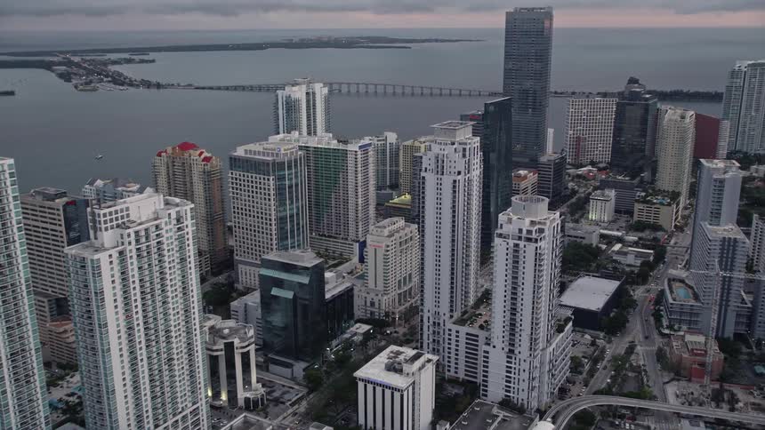 Aerial view of downtown Miamis skyscrapers on the bay at sunset with cloudy skies in the background