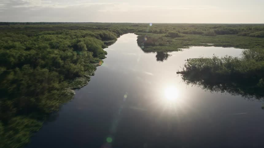 Fly over the St Johns River during sunrise captured in stunning aerial footage