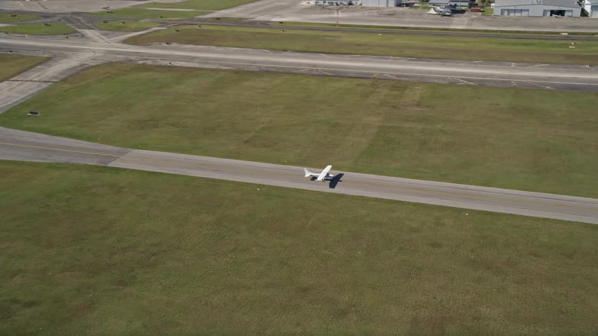 A small airplane is approaching and landing at St Lucie County International Airport in Florida during the daytime