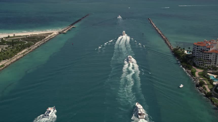 Aerial view of ferries sailing along Government Cut on a partly cloudy day in Miami Florida