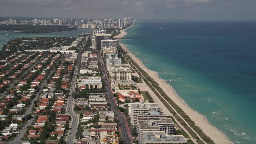 Aerial view of Surfsides coastal neighborhoods beachside condos and seashores along Collins Avenue in Miami Dade County Florida