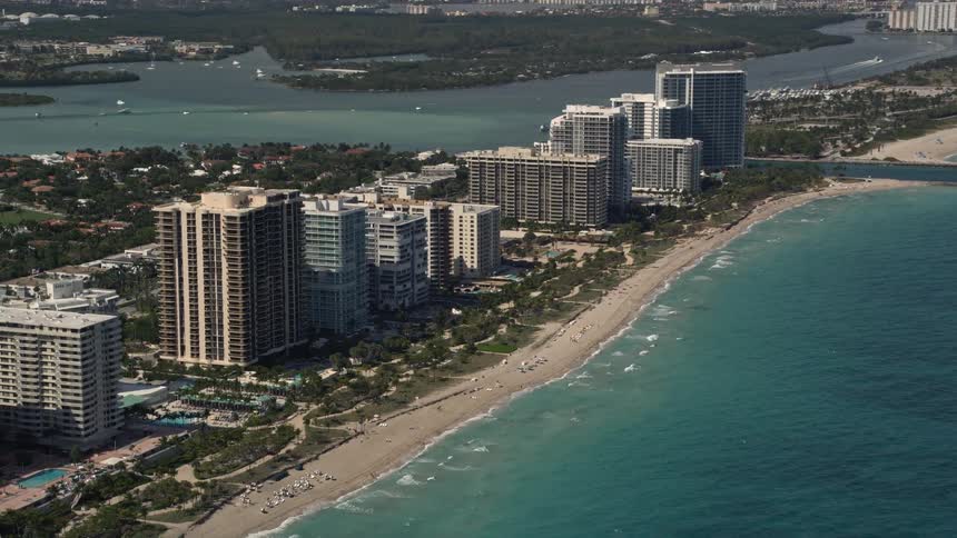 A stunning aerial view of beachfront hotels and condos in Bal Harbour Florida with blue ocean waters and sandy shores visible