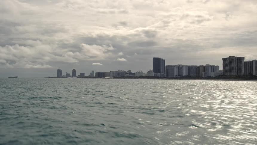 Aerial view of low altitude shoreline condos in Miami Beach Florida overlooking the Atlantic Ocean during an overcast day