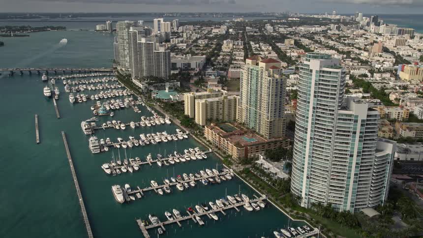 An aerial view showcasing the stunning skyline of residential skyscrapers and marina featuring yachts in South Beach Miami Florida
