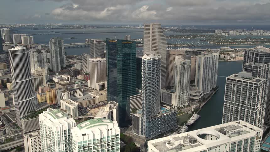 Approaching modern high-rises and hotels in Downtown Miami Florida with a aerial view