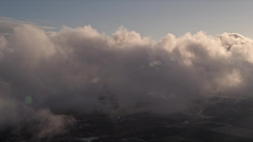 Aerial footage of thick clouds at sunset over Kendall in Florida
