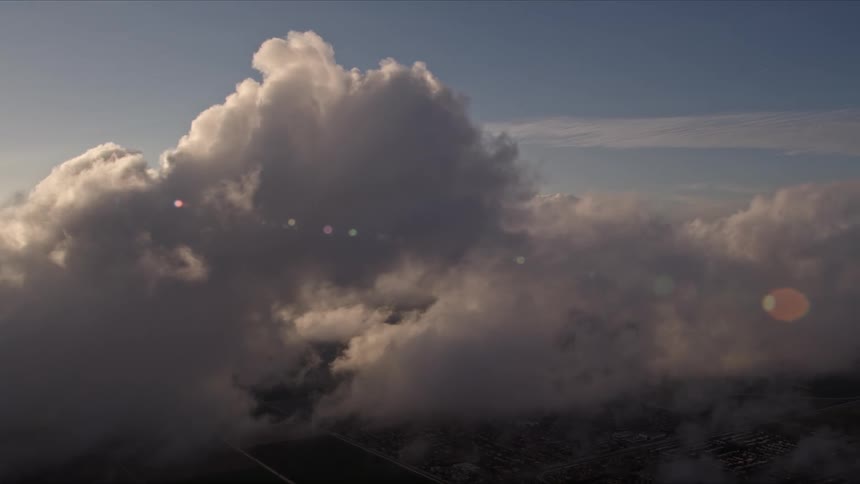A stunning aerial view of Cumulus clouds during dusk over the Florida coast