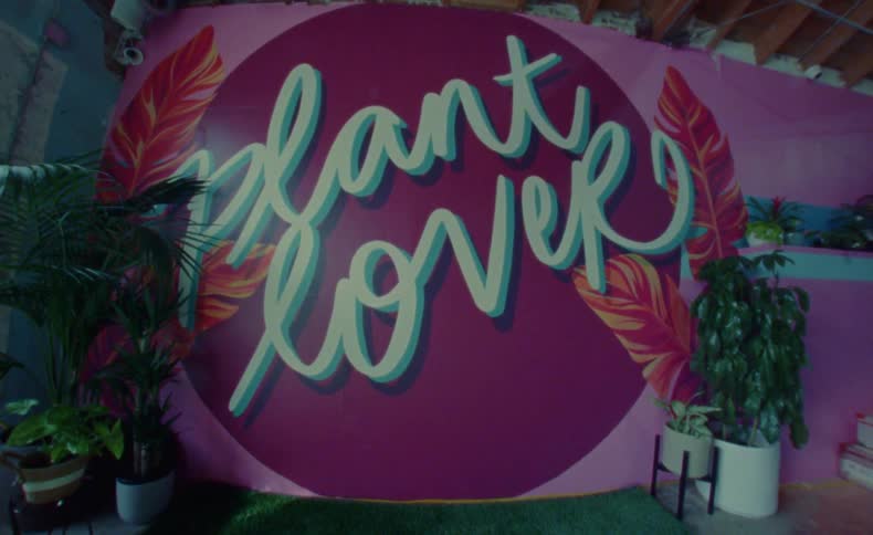 A very stylish logo is painted on the wall of a small business