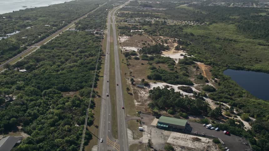 Aerial footage of cars driving on State Route 5 through Fort Pierce Florida on a sunny day