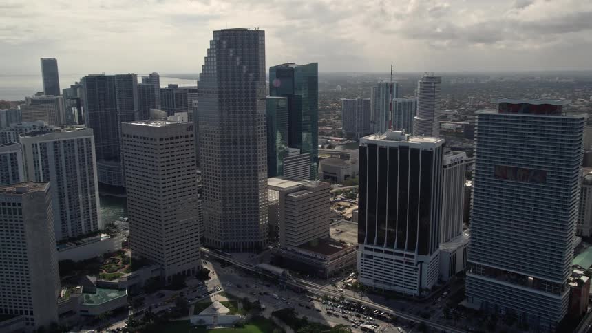 Southeast Financial Center skyscraper captured from an aerial view on a cloudy day in downtown Miami Florida with passing traffic