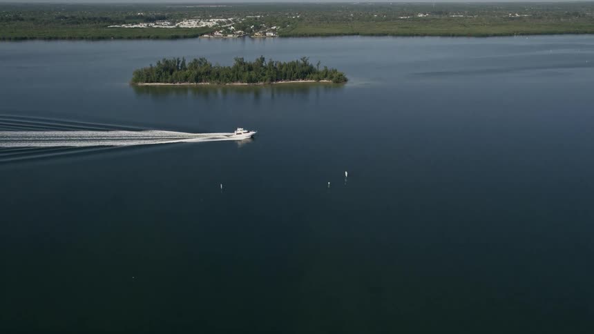 Approaching a fishing boat on the Indian River in Florida this 5K aerial footage captures the sunny and natural beauty of the river as the boat sails towards the camera