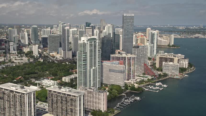 Flying over the bayfront condominium complexes and approaching the downtown Miami hotel and skyscrapers capturing the citys hustle and bustle coastline and residential areas