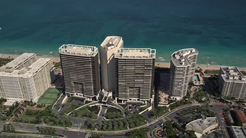 Breathtaking aerial view of luxurious beachfront hotel resort in Bal Harbour FL with crystal clear waters and stunning skyline in the background