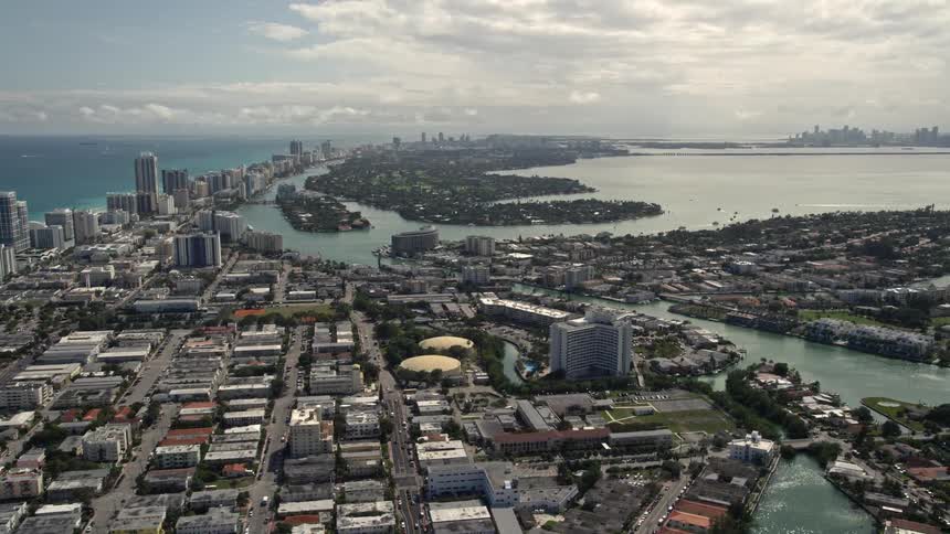 Aerial view of islands near Miami Beach Florida captured in 5K stock footage on a partly cloudy day showcasing the communitys seaside residential areas