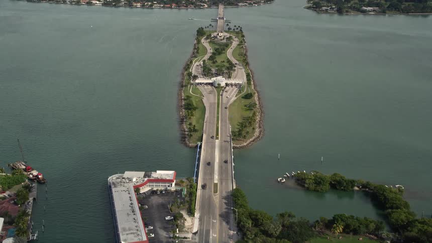 Driving over the Broad Causeway from North Miami towards Bay Harbor Islands Florida on a sunny day with light traffic