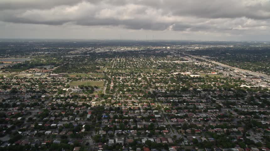 Aerial footage of suburban neighborhoods in Miami Shores Florida on a partly cloudy day