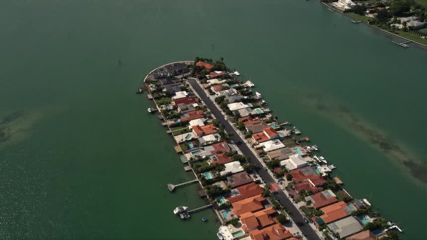 Aerial fly over of waterfront homes on an island community in Biscayne Point Florida
