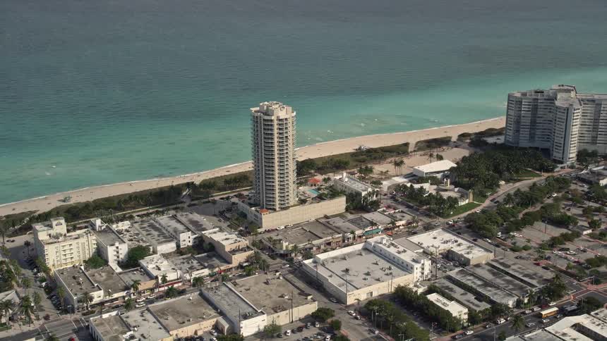 A stunning aerial view of a beachfront condominium complex in the metropolis of Miami Beach Florida located near the ocean