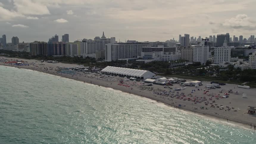 A beautiful aerial view of Miami Beachs bustling coastline and oceanfront hotels during a sunny day