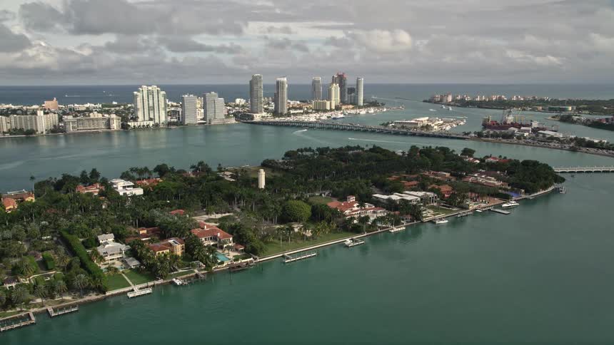 Aerial footage of luxurious mansions featuring boating docks on Star Island Floridas waterfront