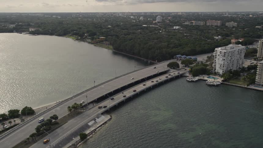 Aerial view of traffic crossing the Rickenbacker Causeway from Miami to the mainland with the city skyline visible in the distance