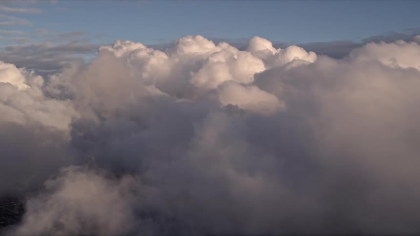 Approaching thick cloud cover during a beautiful Southern Florida sunset while flying over Miami