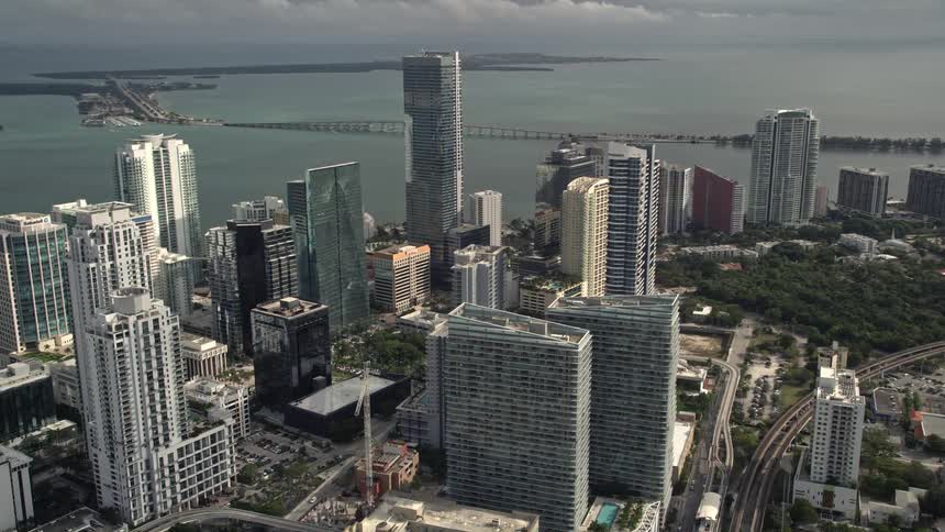 Aerial footage showcasing the towering skyscrapers surrounding the Four Seasons Hotel alongside the downtown area of Miami Florida - perfect for sightseeing and tourism in this metropolitan area
