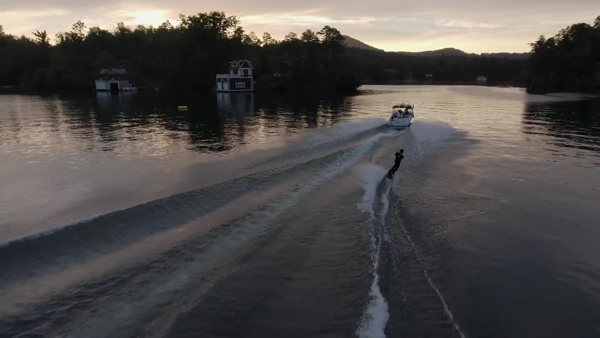A person is wakeboarding on a lake