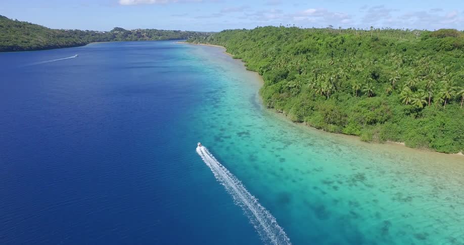 A boat floats just off the coast