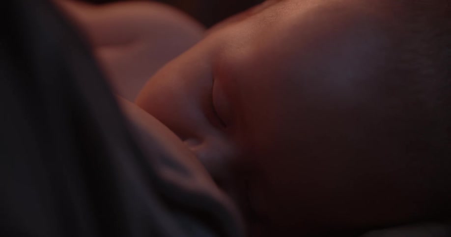 Mother breastfeeds newborn baby