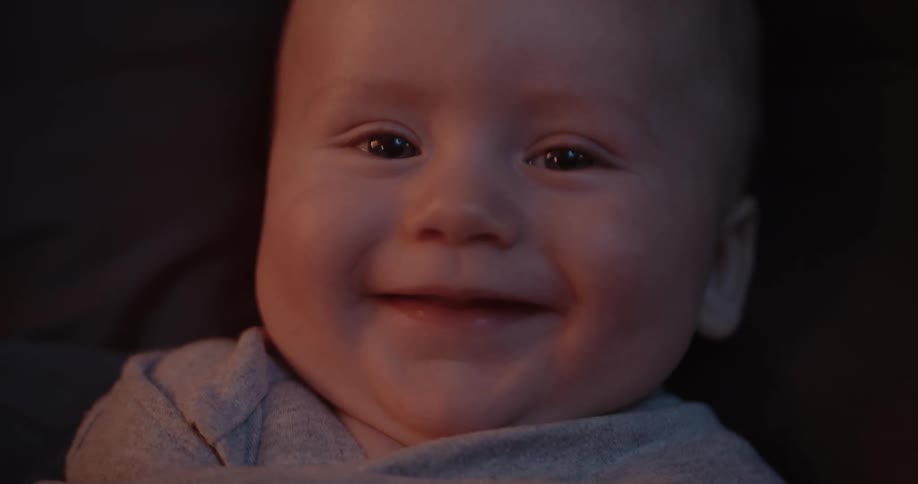 A baby smiles and laughs