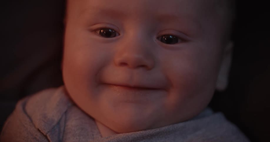 Close up of newborn babys face smiling