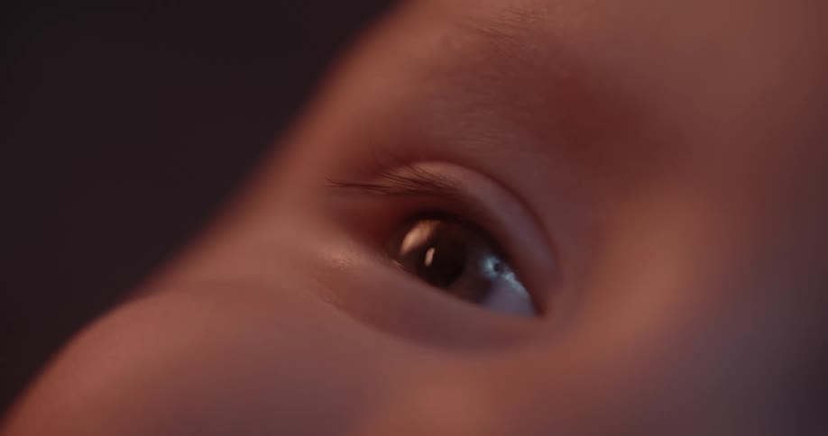 A babys eye as it looks around and the baby appears to smile