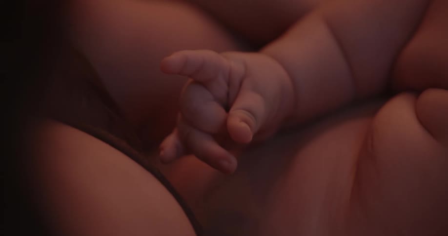 A mother is holding her baby