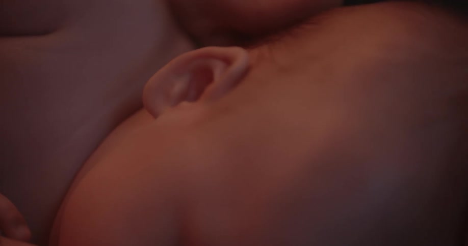 A person is touching brushing the babies head